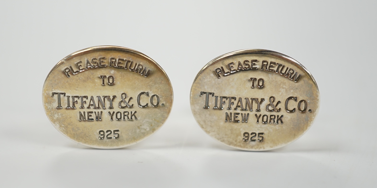 A modern pair of Tiffany & Co gilt 925 oval cufflinks, 19mm, with pouch and box.